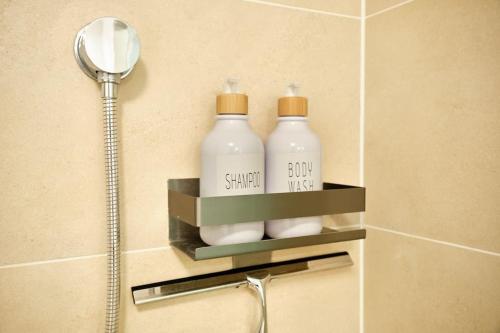 two bottles of soap on a shelf in a bathroom at Free Parking I Balcony I 5 min to Train Station in Vienna