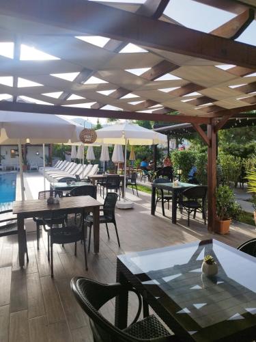 an outdoor patio with tables and chairs and umbrellas at Vespera hotel in Dalyan
