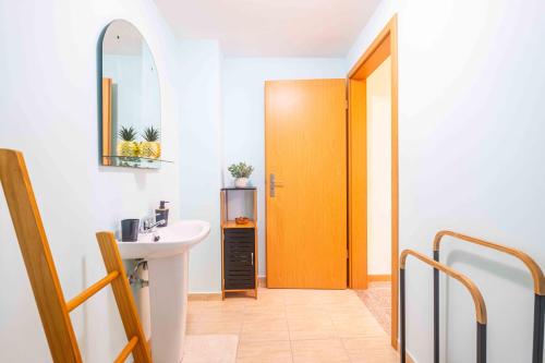 a bathroom with a sink and a yellow door at Santana House Holiday Rental - For Nature Lovers by YOUR KEY in Santana