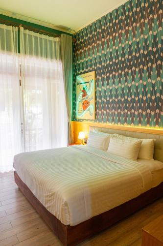a bedroom with a large bed in a room at Senglao Boutique Hotel Luang Prabang in Luang Prabang