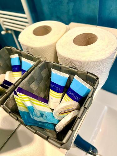 a basket with toiletries and rolls of toilet paper at Summerland Seaview Apartments in Mamaia