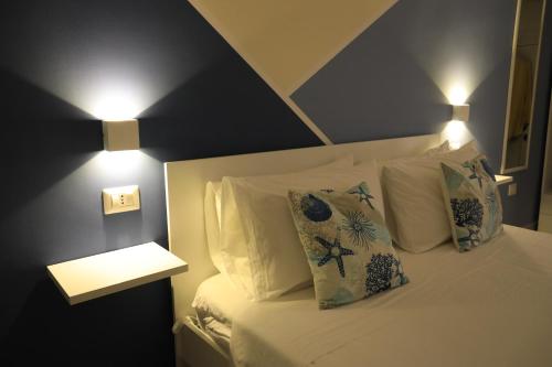 a bedroom with a bed with two pillows on it at Casa Onofrio Tropea in Tropea