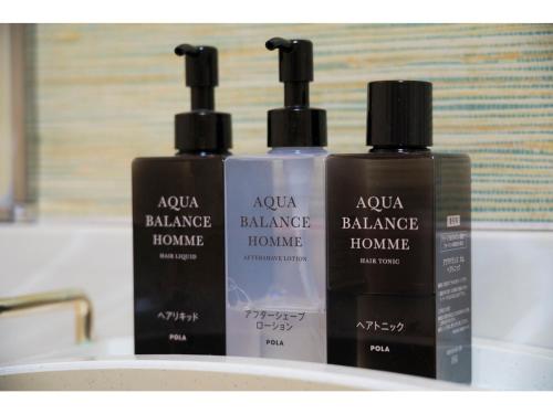 a group of three bottles of hair products on a sink at SUIHOKAKU HOTEL - Vacation STAY 49743v in Fukuoka