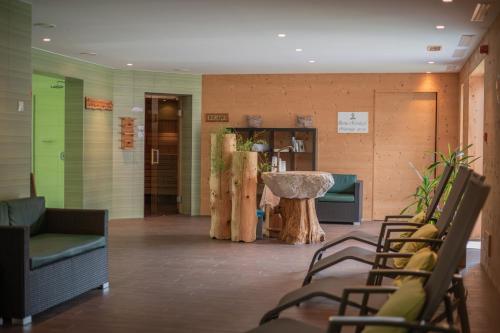 a lobby with chairs and a table in a room at Camping Sass Dlacia in San Cassiano