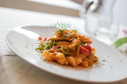 a white plate of food on a table at Camping Sass Dlacia in San Cassiano