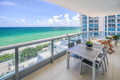 a balcony with a table and a view of the ocean at MonteCarlo Miami Beach in Miami Beach