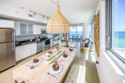 a kitchen with a table and a view of the ocean at MonteCarlo Miami Beach in Miami Beach