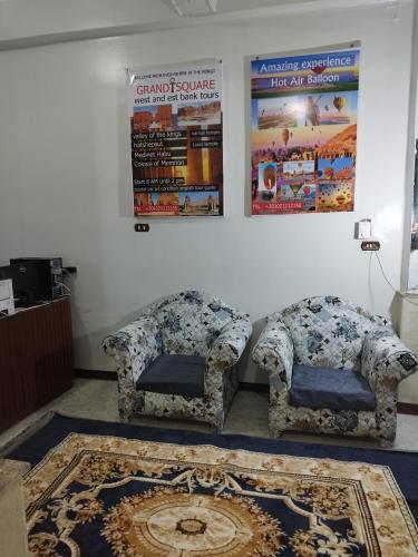 a room with two chairs and a rug at Grand Square Hostel Luxor in Luxor