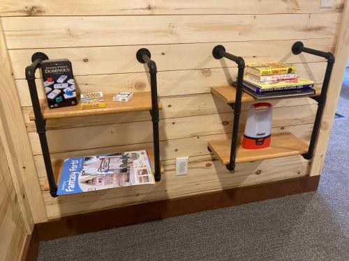 a wall with two shelves with books on it at Keweenaw Waters Resort in Houghton