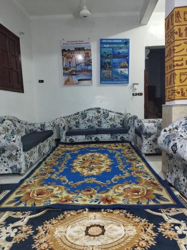a room with a large rug on the floor at Grand Square Hostel Luxor in Luxor