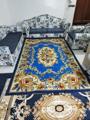 a blue and gold rug on the floor in a room at Grand Square Hostel Luxor in Luxor