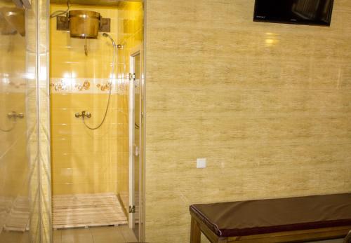 a shower with a glass door in a bathroom at Karavella in Mykolaiv