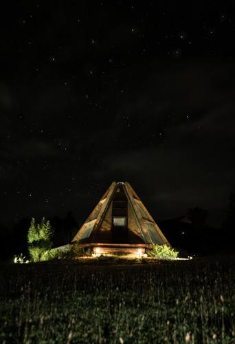 a yurt in the middle of a field at night at Hotel, Glampings y Cabaña Magic Bungalow in Villa de Leyva