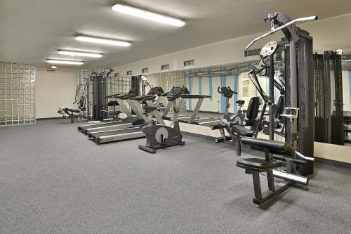 a gym with rows of treadmills and machines at Hotel Šariš in Bardejov