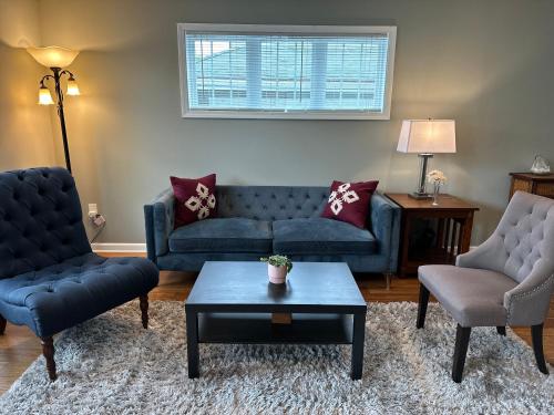 a living room with two couches and a coffee table at Extended & Short Term Stays at The Oasis Group in Minneapolis