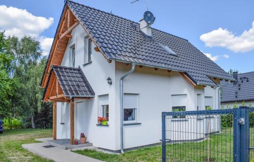 a white house with a black roof at 2 Bedroom Gorgeous Home In Niesulice in Niesulice