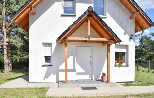 a white house with a white door and windows at 2 Bedroom Gorgeous Home In Niesulice in Niesulice