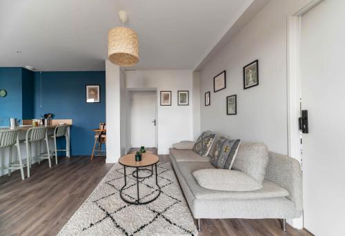 a living room with a couch and a table at Résidence Léon Blum - Appartements design - Parking in Clermont-Ferrand