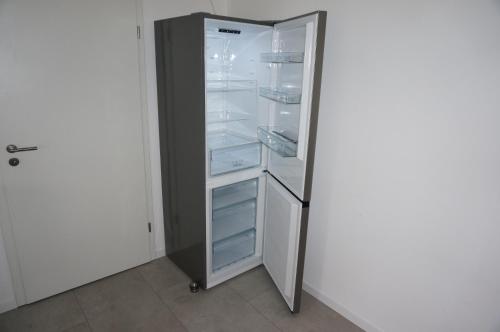 a refrigerator with its door open in a room at Ferienwohnung "Dream Suite" - im Coburger Wonderland - Ihr Zuhause auf Zeit! in Coburg