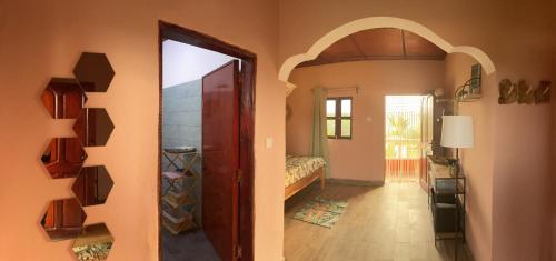 a hallway with a door leading to a bedroom at Alhasia Ecoville Jambur Gambia in Jambur