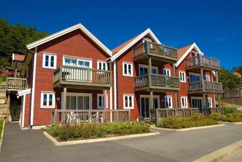 a large red brick building with balconies on it at Tregde Ferie in Mandal