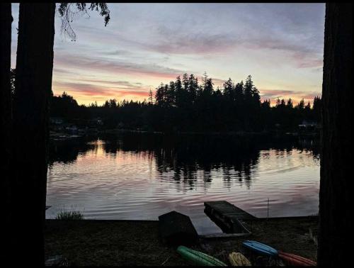 a view of a lake with a sunset in the background at Lake St Claire Waterfront, 1 beds, 1 bath in Olympia