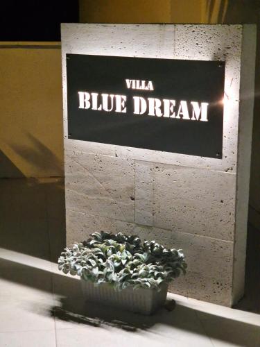 a blue dream sign on a wall with a pot of plants at 5 stars 2 bedrooms villa BLUE DREAM village Pisak Croatia in Pisak