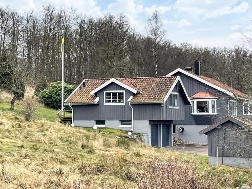 a black and white house on a hill at 4 star holiday home in Romelanda in Romelanda