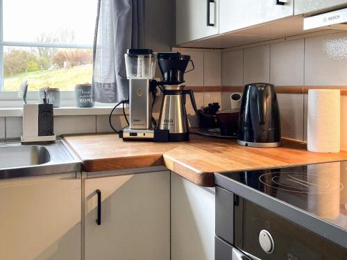 a kitchen with a blender on a wooden counter top at 4 star holiday home in Romelanda in Romelanda