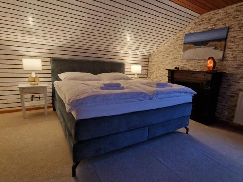 a bedroom with a large bed and a brick wall at Marburg Apartment geräumiger Lukas in ruhiger Waldrandlage mit Wintergarten in Marburg an der Lahn