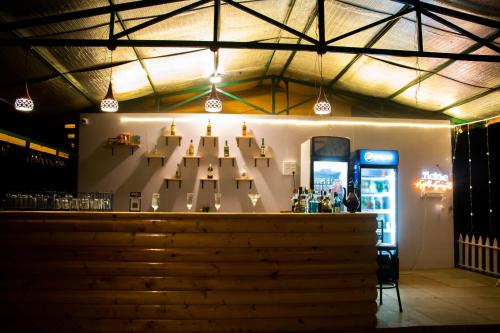 a bar with a display of wine glasses at Eco Wooden Homes in Benaulim