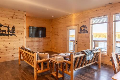 a log cabin living room with a couch and a table at Keweenaw Waters Resort in Houghton