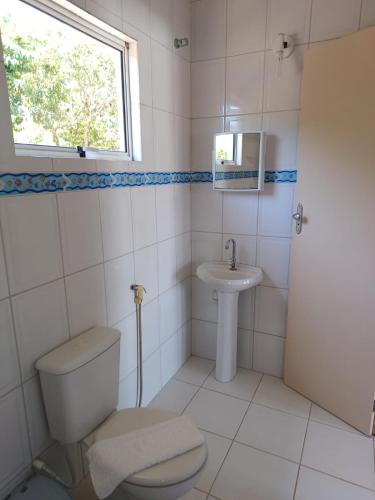 a bathroom with a toilet and a sink at Morada das Palmeiras in Barra Grande