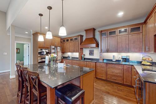 a kitchen with wooden cabinets and a large island at Tranquil Point in Mineral