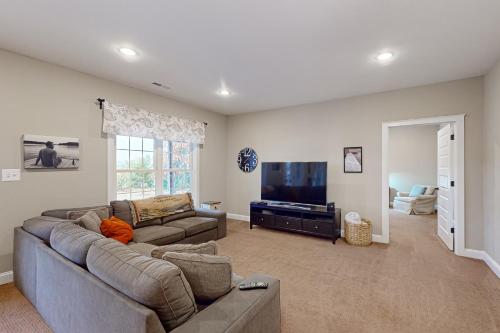 a living room with a couch and a flat screen tv at Tranquil Point in Mineral