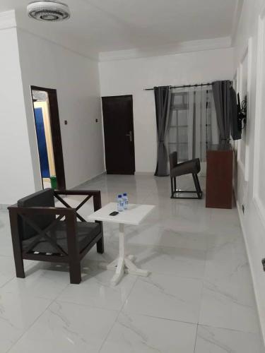 a living room with a table and a chair at ASVA BEACH Resort in Grand-Popo