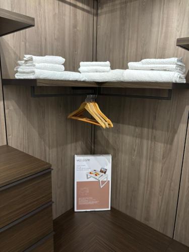 a shelf with towels and a sign in a closet at Incanto in Sestu