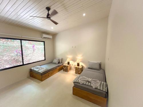 a bedroom with two beds and a window at House 15 Min From The Beach With River Access in Ojochal