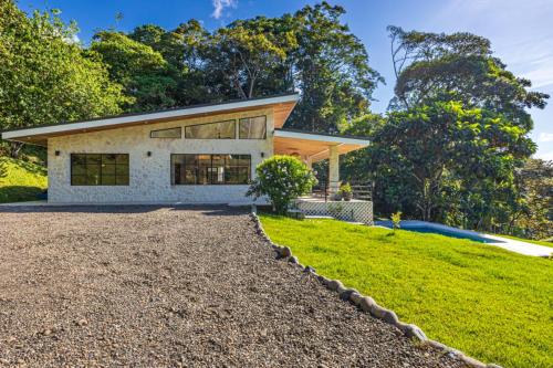 a house with a gravel driveway in front of it at House 15 Min From The Beach With River Access in Ojochal