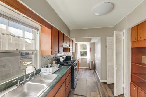 a kitchen with wooden cabinets and a sink at Close to University and Dtwn Home in Dayton in Dayton