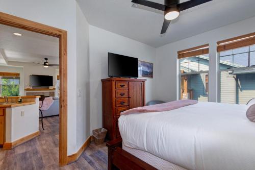 a bedroom with a bed and a dresser with a television at Fox Pointe Condo by Park City Vacations in Park City