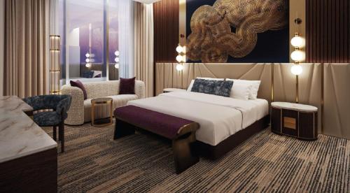 a hotel room with a bed and a chair at Hard Rock Hotel & Casino Bristol in Bristol