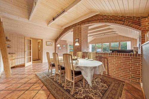 a dining room with a table and chairs at Cozy And Spacious Holiday Home Near Torup Strand Close To The North Sea in Fjerritslev