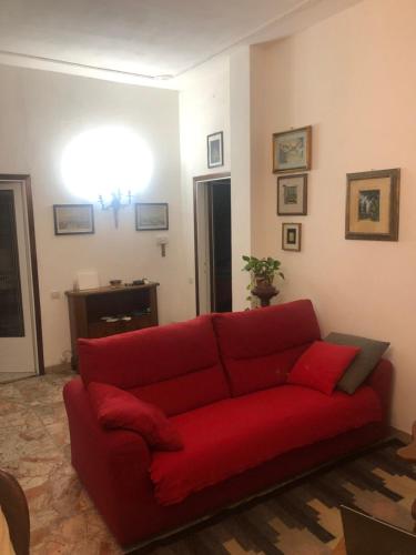 a red couch sitting in a living room at Dolce casa con terazza in San Piero a Sieve