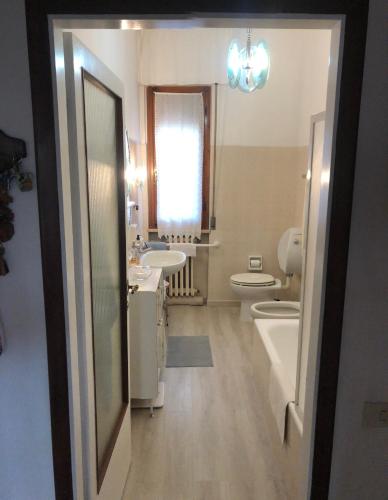a bathroom with a sink and a toilet and a mirror at Dolce casa con terazza in San Piero a Sieve