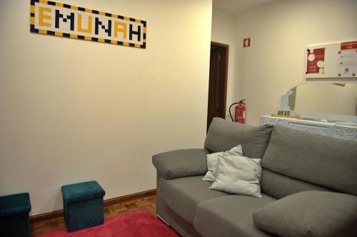 a living room with a couch and a tv at Emunah - no coração de Aveiro in Aveiro