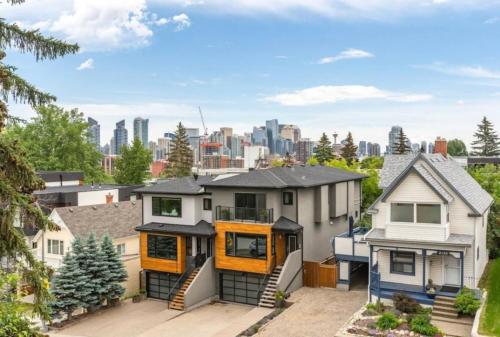a home in the city with a view of the city at Oakwoods 1BR Suite in Bankview in Calgary