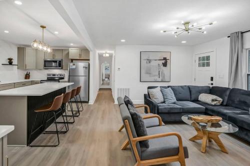 a living room with a blue couch and a kitchen at Earlewood Ranch - 4BR, 3BA in Columbia