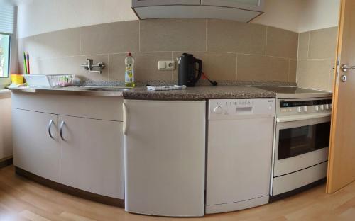 a kitchen with white appliances and a counter top at FeWo Lotti - 5 Personen, ruhige Lage, WLAN in Kurort Oberwiesenthal