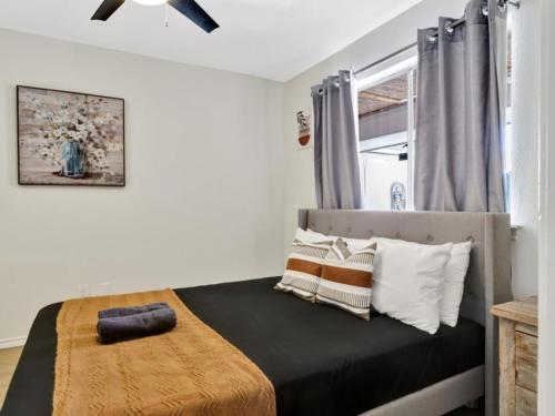 a bedroom with a bed and a ceiling fan at City Gem 4BR with POOL Sleeps 8 in Plano